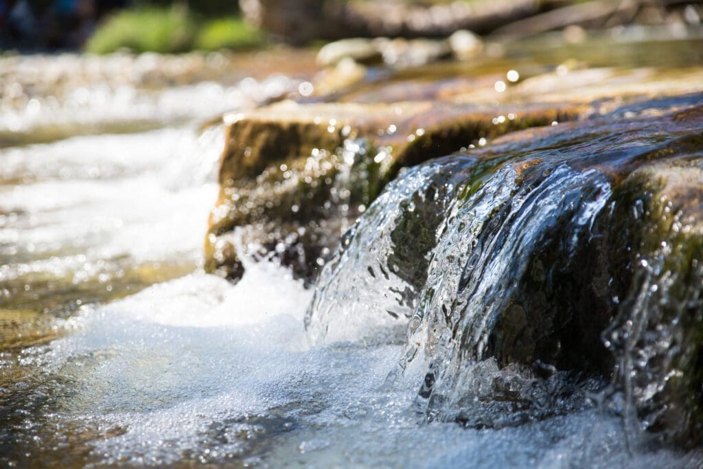 A close up of water flowing over rocks