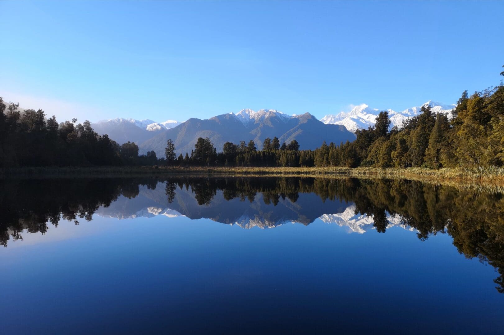 A lake with mountains in the background